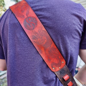 Red Dragon & Phoenix hand crafted thick premium leather guitar strap.  Fully adjustable sizing to fit your perfect custom height  position.