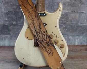 Dragon Fire Leather Guitar Strap in Antique Tan. Dragon and Dragon Scales Handmade Instrument Strap. Adjustable sizing for custom height.
