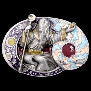 May include: A detailed metal belt buckle featuring a wizard holding a staff with a star. The wizard is depicted with a long white beard and is surrounded by celestial elements, including stars and a planet-like design. The buckle has a silver finish with colorful accents.