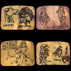 May include: Four rectangular brass belt buckles with etched black line art. The buckles feature cartoon figures and text including "Lizards", "Belinda", "Cheech Wizard Resting", and "Troop".