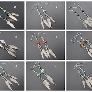May include: Nine pairs of silver dangle earrings with feather charms. Each pair features a different colored gemstone bead.