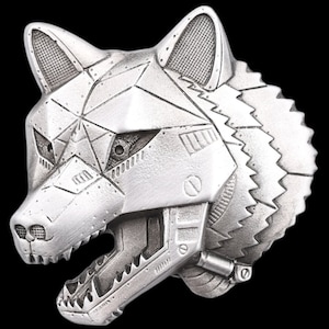 May include: A silver metal wolf head sculpture with a detailed, mechanical design. The wolf's mouth is open, revealing sharp teeth and intricate gears. The sculpture has a textured surface and a geometric pattern.