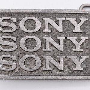 May include: A silver belt buckle with the word "SONY" embossed three times.