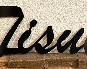 May include: Black metal sign with the word "Tissue" written in a cursive font.