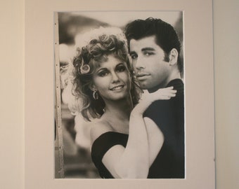 May include: Black and white photograph of a couple, a woman with curly hair and a man with dark hair, posing together.