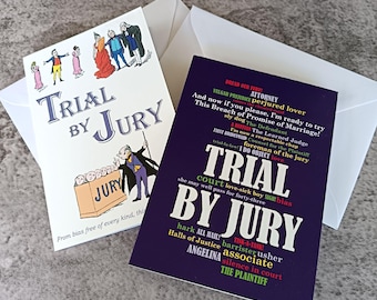 May include: Two greeting cards featuring Trial by Jury themes. One card is white with a colorful illustration of a courtroom scene and the text Trial by Jury. The second card is dark purple with a collage of various legal-themed words and phrases.