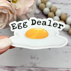 May include: A fried egg sticker with the text 