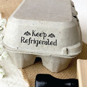 May include: A wooden stamp with a black handle and the words 
