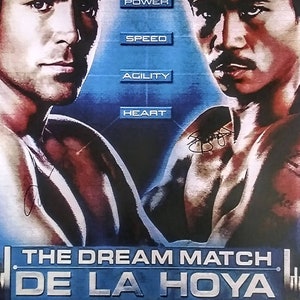 May include: A boxing poster featuring a blue and silver design with the text "THE DREAM MATCH DE LA HOYA VS PACQUIAO DECEMBER 6, 2008 MGM GRAND LAS VEGAS". The poster features a photo of Oscar De La Hoya and Manny Pacquiao.