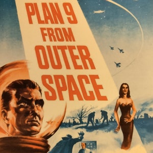 May include: A vintage movie poster for the film "Plan 9 From Outer Space" featuring a man in a spacesuit, a woman in a black dress, and a flying saucer. The poster is in shades of blue, red, and white.
