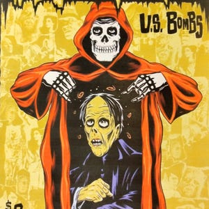 May include: A concert poster for the Misfits, a horror punk band, performing with U.S. Bombs. The poster features a red-hooded figure with a skull face, holding a man with a green face in a black suit. The text on the poster reads "Misfits vs. U.S. Bombs", "Sunday House of Blues", "July 20th Los Angeles CA", and "$8".