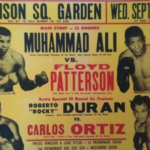 May include: A vintage boxing poster advertising a fight between Muhammad Ali and Floyd Patterson at Madison Square Garden on Wednesday, September 20th. The poster also advertises a co-feature fight between Roberto "Rocky" Duran and Carlos Ortiz.