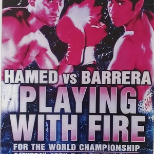 May include: A boxing poster with a red and white color scheme featuring two boxers, Naseem Hamed and Marco Barrera, with the text "HAMED vs BARRERA PLAYING WITH FIRE" and "FOR THE WORLD CHAMPIONSHIP SATURDAY, APRIL 7 9 PM ET/6 PM PT SEE IT LIVE".