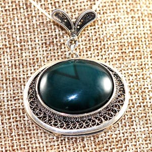 925 Sterling Silver Filigree oval shaped pendant with many different stones incased in . Unique handmade in our old workshop .