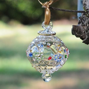 Egyptian Blown Glass Ornament a clear design with small colored flower with golden accent. Made by professional to decorate your areas.