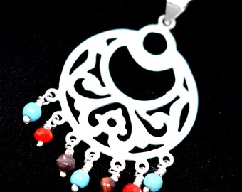 May include: A silver pendant with an openwork design, featuring a circular shape with intricate cut-out patterns. The pendant is adorned with small, colorful beads in red, turquoise, and brown, suspended from the bottom.