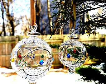 Egyptian Blown Glass Ornament a clear design with small colored flower with golden accent. Made by professional to decorate your areas.