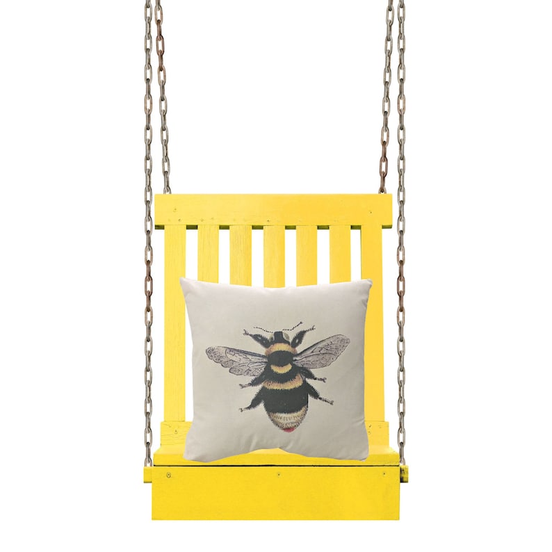 May include: A yellow wooden swing suspended by metal chains, with a cream cushion. The cushion displays a detailed illustration of a bumblebee in black, yellow, and white. The swing is set against a white background.