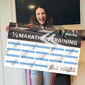 May include: A half marathon training chart with 18 weeks of training schedule. The chart is printed on a white background with blue and black text. The chart is titled "1/2 Marathon Training" and includes the text "13.1 Miles".