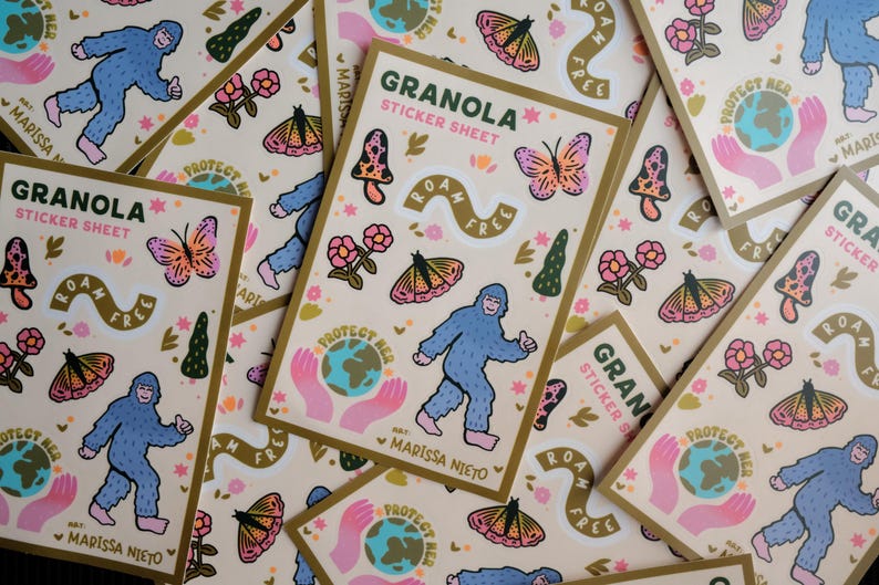 May include: A collection of "Granola" sticker sheets with a beige background and gold borders. Each sheet features a blue Bigfoot, butterflies, mushrooms, flowers, and the text "Roam Free" and "Protect Her".