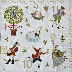 May include: White paper napkin with illustrations of the Twelve Days of Christmas. Features include birds, swans, musicians, and numbers in gold. Decorative holly and pear accents are scattered throughout the design.