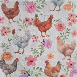 May include: A white paper napkin with a repeating pattern of chickens and flowers. The chickens are various shades of brown, gray, and blue. The flowers are pink, orange, and purple, with green leaves.