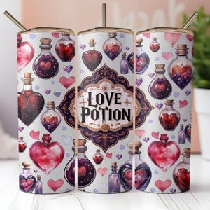 May include: A white stainless steel tumbler with a pink, purple, and gold design. The tumbler features a repeating pattern of hearts and potion bottles with the words "Love Potion" in a gold script font.