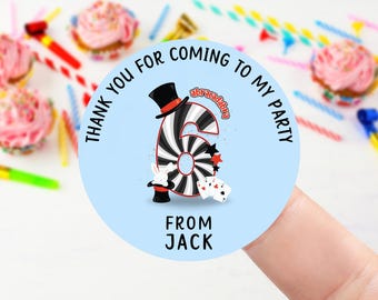 May include: A light blue party favor sticker with the text "Thank you for coming to my party" in a circular design. The sticker features a black and white striped number 6 with a magician's hat, playing cards, and the name "Jack".