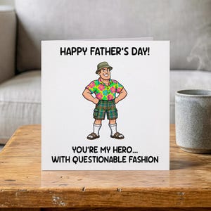 May include: A Father's Day card with the text "HAPPY FATHER'S DAY!" and "YOU'RE MY HERO... WITH QUESTIONABLE FASHION." The card features a cartoon illustration of a man in a Hawaiian shirt and plaid shorts.