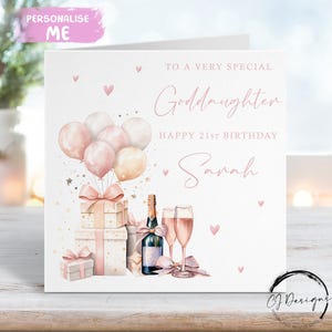 May include: A white greeting card with pink text and illustrations. The card reads "To a Very Special Goddaughter, Happy 21st Birthday Sarah." It features pink balloons, gift boxes, champagne, and hearts. The top left corner has the text "Personalise Me."