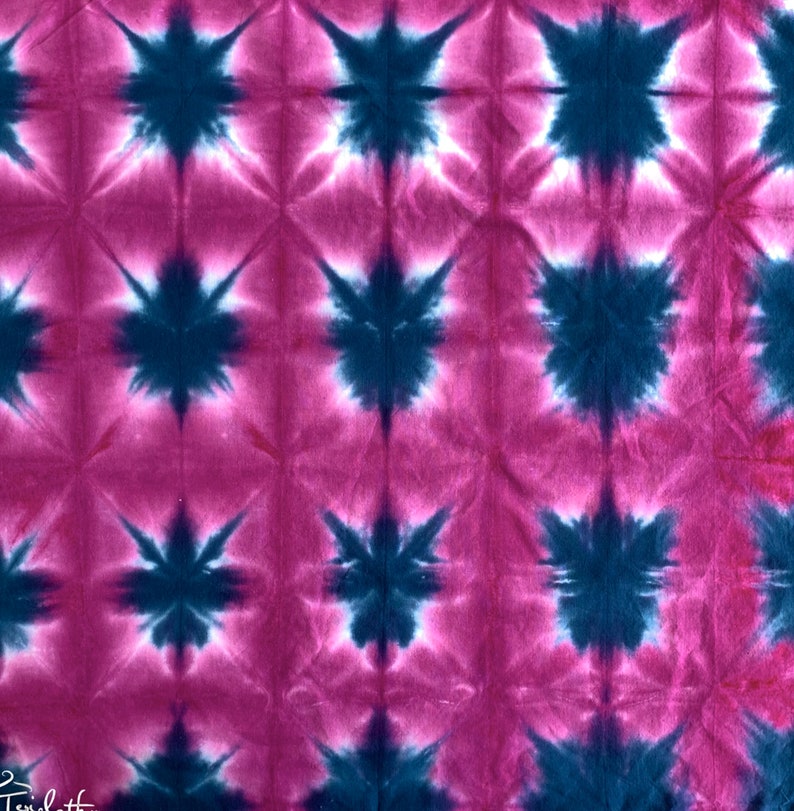 May include: A pink and blue tie-dye fabric with a repeating starburst pattern.