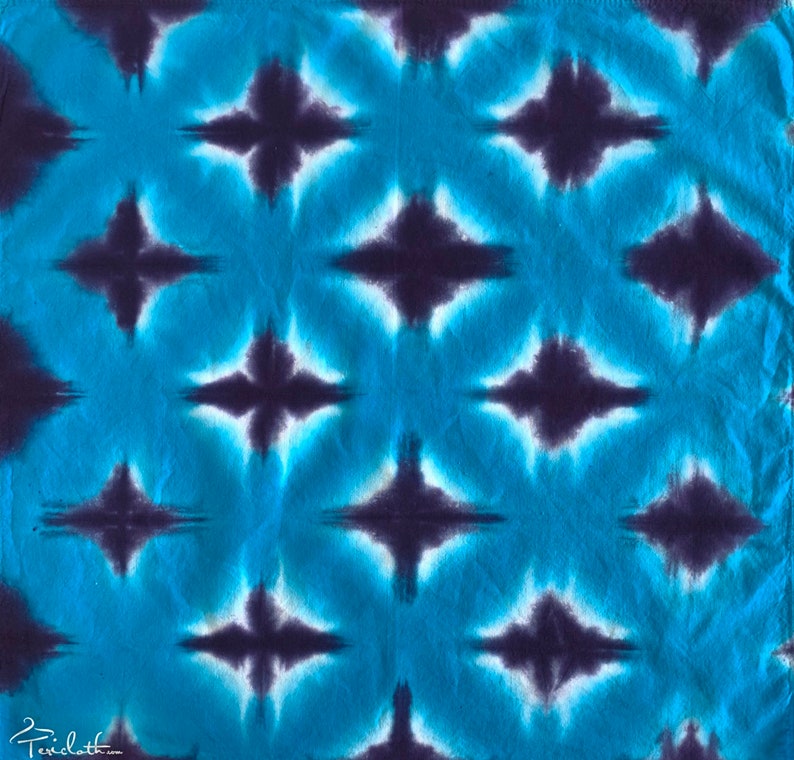 May include: A blue and purple tie-dye fabric with a repeating diamond pattern.
