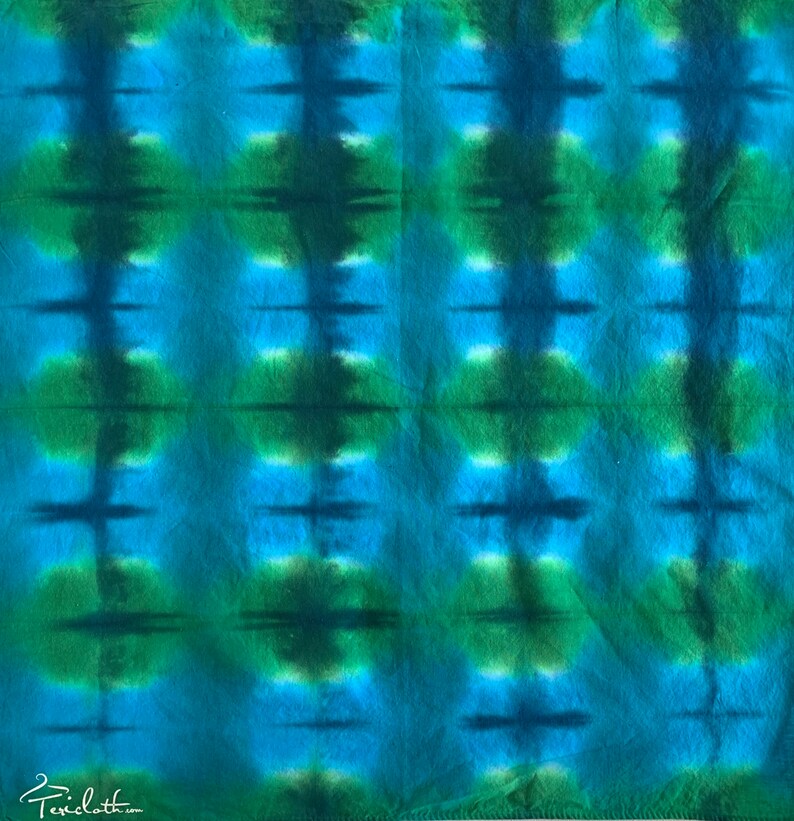 May include: A blue and green tie-dye fabric with a repeating pattern of vertical stripes and horizontal lines.