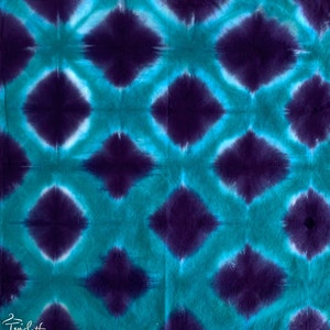 May include: A tie-dye fabric with a repeating pattern of teal and purple diamond shapes.