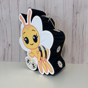 May include: A set of three ceramic mugs with a speckled, matte finish. The mugs are in shades of cream, light gray, and dark gray. Each mug has a simple, minimalist design and a rounded handle.