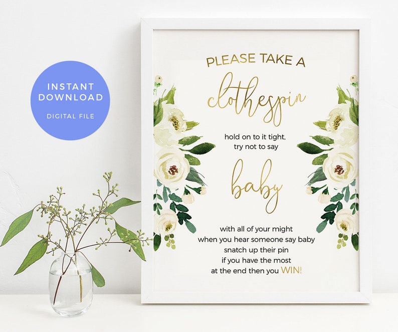 May include: A white frame with a gold floral design and the text "PLEASE TAKE A clothespin hold on to it tight, try not to say baby with all of your might when you hear someone say baby snatch up their pin if you have the most at the end then you WIN!"