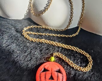 jack-o'-lantern on gold chain