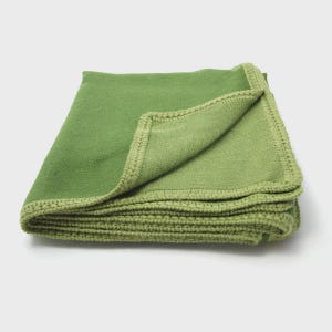 May include: Folded green blanket with a lighter green border. The blanket is made of a soft material and is folded neatly, showing the texture and color variations. The edges are neatly stitched.