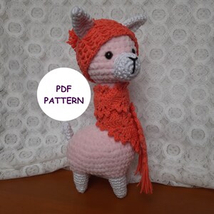 May include: A pink crocheted llama wearing a red crocheted hat and scarf. The text "PDF PATTERN" is visible in the image.