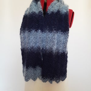 May include: A blue and light blue striped scarf with a fuzzy texture. The scarf is displayed on a mannequin.
