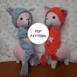 May include: Two crocheted llama amigurumi toys wearing hats and scarves. The llama on the left is wearing a light blue hat and scarf, while the llama on the right is wearing a red hat and scarf. The text "PDF PATTERN" is visible in the image.