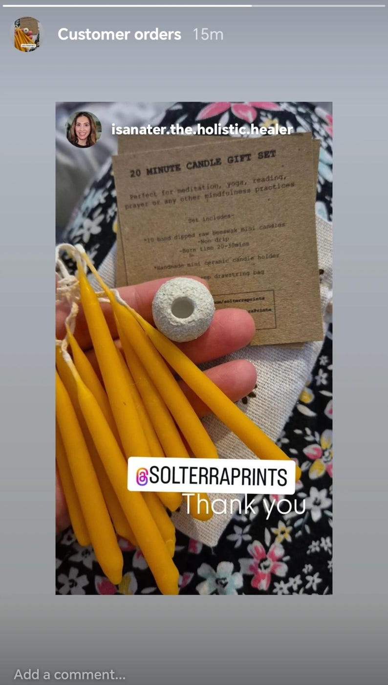 May include: A set of 20-minute beeswax candles in a small gift set. The set includes 10 hand-dipped candles, a ceramic candle holder, and a drawstring bag. The candles are yellow and the holder is white. The text on the card reads "20 Minute Candle Gift Set. Perfect for meditation, yoga, reading, prayer or any other mindfulness practices. Set includes: 10 hand dipped raw beeswax mini candles - non-drip - burn time 20-30mins. Handmade mini organic candle holder. Drawstring bag."