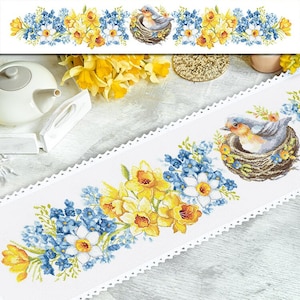 May include: White embroidered table runner with a blue bird in a nest and yellow daffodils and blue forget-me-nots.