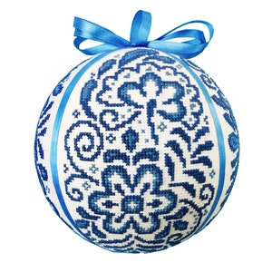 May include: A white Christmas bauble with a blue floral pattern and a blue ribbon bow.
