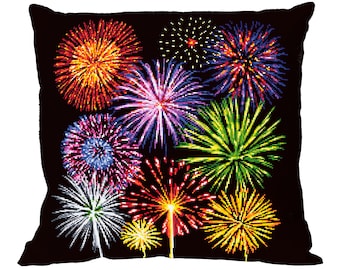 May include: A black pillow with a colorful firework design. The fireworks are in various shades of red, orange, yellow, green, blue, and purple.