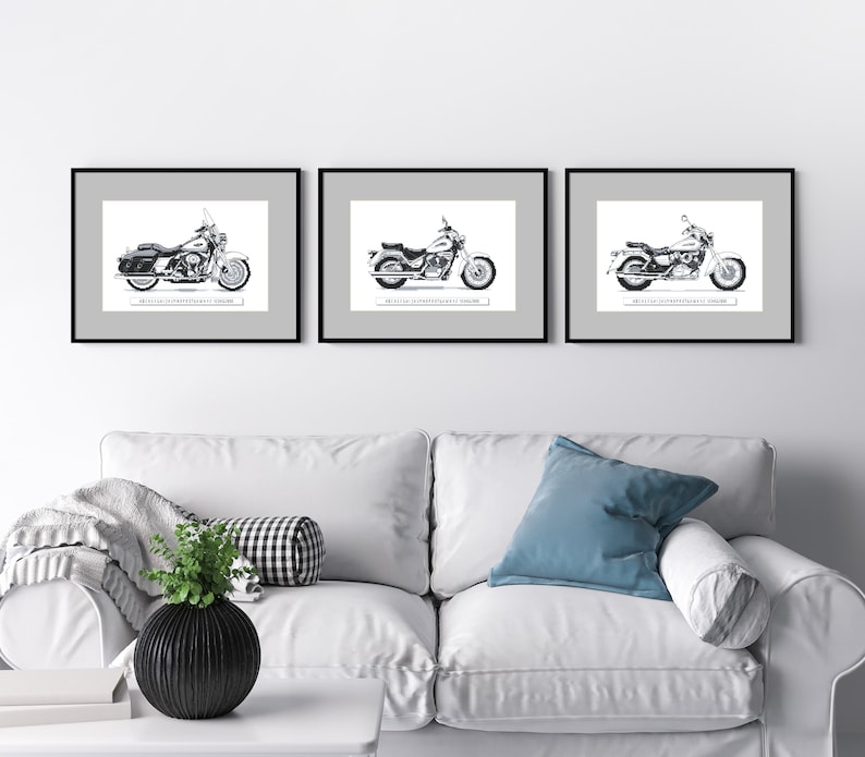 May include: Three black framed prints of motorcycle drawings. Each print features a different motorcycle design. The prints are hung on a white wall above a white couch.