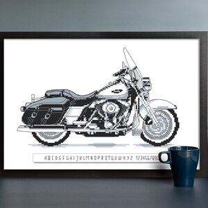 May include: Black and white pixel art illustration of a motorcycle. The motorcycle has a large, rounded front wheel and a smaller, rounded rear wheel. The motorcycle has a saddlebag on the right side and a windshield.