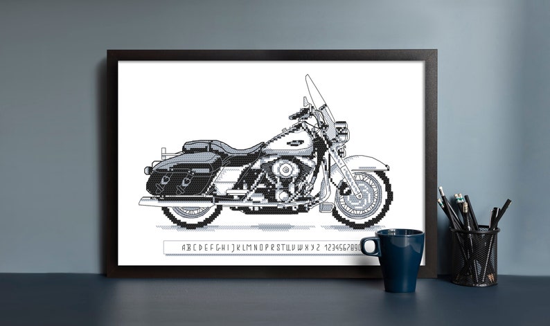 May include: Black and white pixel art illustration of a motorcycle. The motorcycle has a large, rounded front wheel and a smaller, rounded rear wheel. The motorcycle has a saddlebag on the right side and a windshield.