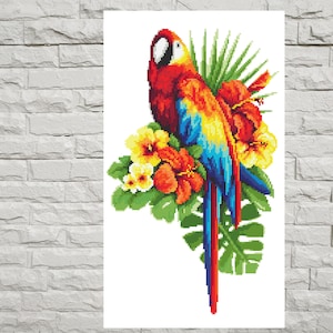 May include: A colorful parrot with red, yellow, and blue feathers perched on a branch of tropical leaves and flowers. The flowers are red, yellow, and orange.