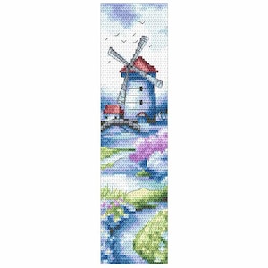 May include: Cross-stitch bookmark featuring a windmill scene. The windmill has a red roof and white body, set against a blue sky with birds. A bridge and water with colorful flowers are in the foreground. The bookmark is rectangular.